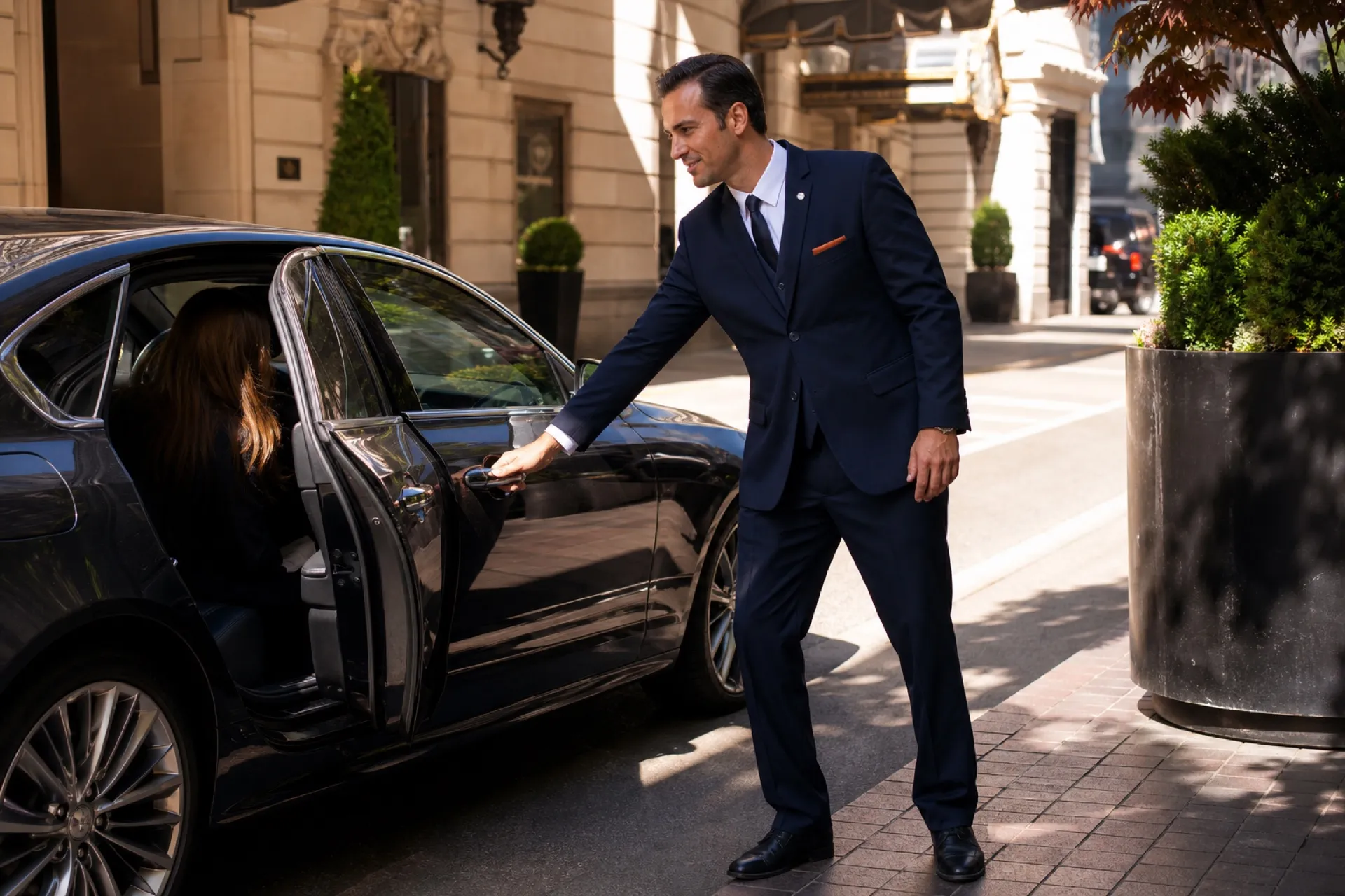 Uniformed valet opening a guest vehicle at a Chicago hotel entrance